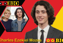 Freigestelltes Frontalbild von Charles Ezekiel Mozes 2026 in Jeansjacke und grauem Shirt für Biografie-Steckbrief.